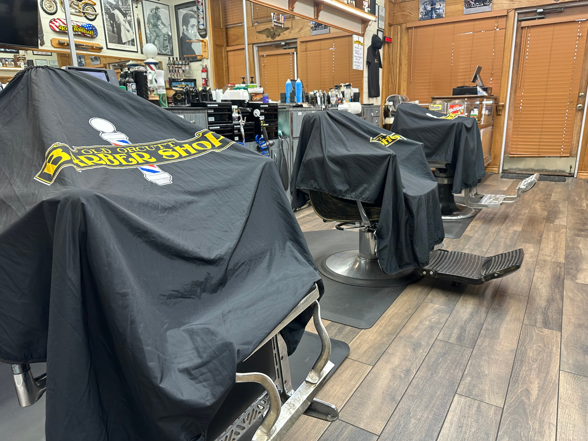 Barber chairs draped with Old Orcutt Barber Shop covers